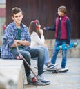 Teen and his friends after conflict outdoors Royalty Free Stock Photo