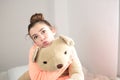 Teen hugging her teddy bear
