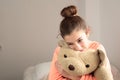 Teen hugging her teddy bear