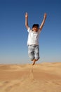 Teen jumping in the desert Royalty Free Stock Photo