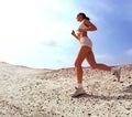 Teen lady running on sand