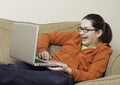 Teen laughing at laptop