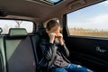 Teen in leather jacket crying seat car rubs eyes Royalty Free Stock Photo