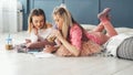 Teen leisure girls hanging out floor home drawing Royalty Free Stock Photo