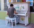 A young man playing a piano outside an art gallery in southern ontario