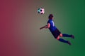 Teen male football or soccer player, boy on gradient background in neon light - motion, action, activity concept Royalty Free Stock Photo