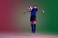Teen male football or soccer player, boy on gradient background in neon light - motion, action, activity concept Royalty Free Stock Photo
