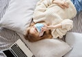 Teen in medical mask talking via phone, top view