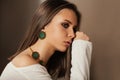 Teen model with elegant jewelery on brown background