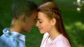 Teen multiracial couple touching foreheads in park, trustful relations, love Royalty Free Stock Photo