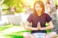 Asian healthy teen wear casual cloth doing yoga in park Royalty Free Stock Photo