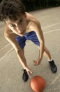 Teen plays in basketball on the street