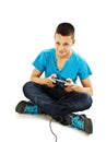 Teen plays on the joysticks sitting on the floor