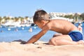 Teen plays in the sand on the sea beach