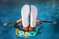 Teen in pool with upturned soles, perfect for text placement. Royalty Free Stock Photo