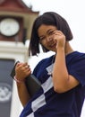 Teen reading clock tower.