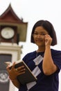 Teen reading clock tower.