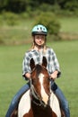 Teen riding her horse