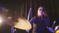 Teen rock music - gothic girl percussion drummer performing with drums