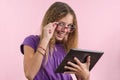 Teen school girl with glasses using a laptop computer Royalty Free Stock Photo