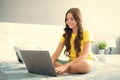 Teen school girl studying at home on bed with laptop. Happy teen girl, positive and smiling emotions. Royalty Free Stock Photo