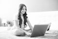 Teen school girl studying at home on bed with laptop. Happy teen girl, positive and smiling emotions. Royalty Free Stock Photo