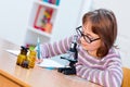 Teen science girl with microscope Royalty Free Stock Photo