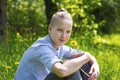 Teen sits on the grass