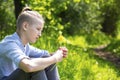 Teen sits on the grass