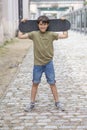 A teenage boy carrying skateboard and smiling Royalty Free Stock Photo