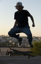 Teen Skateboarder doing jump trick in urban location Royalty Free Stock Photo