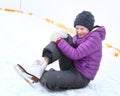 Teen skater girl fall down on ice rink