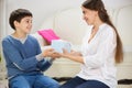 Teen son presenting a gift to mother Royalty Free Stock Photo