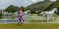 Teen standing on Grass in front of silver horses Royalty Free Stock Photo