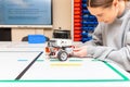 Teen student with diy robot on stem education class.Fixing mechanic toy car.Teen scientist working on new project.Stem education