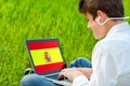 Teen student doing spanish course on laptop.