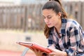 Teen studying memorizing notes in a park