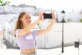 Teen taking slefie or photo in a town