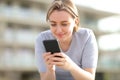 Teen texting on phone in the street Royalty Free Stock Photo