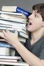 Teen Tries To Carry Unbalanced Stack Of Textbooks