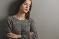 Teen upset,unhappy sad teenage girl stands with her arms crossed,frustrated young woman,problems and misfortunes in her family and Royalty Free Stock Photo