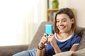 Teen using a blue smartphone at home