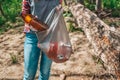 Teen volunteer collects garbage in the Park. The concept of earth day and ecology and environmental conservation. Close up