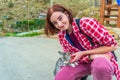 Teen volunteer girl with little cat in small town. Young tourist and cute abandoned hungry kitten. Authentic lifestyle moments.