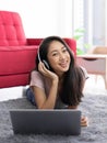 Teen wearing headphones listening to music relax in living room