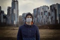 Teen wearing a medical mask against the background of a city against quarantine