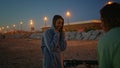 Teen woman dancing evening beach. Unknown man musician playing guitar twilight Royalty Free Stock Photo