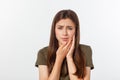 Teen woman pressing her bruised cheek with a painful expression as if she is having a terrible tooth ache Royalty Free Stock Photo