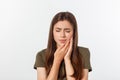 Teen woman pressing her bruised cheek with a painful expression as if she is having a terrible tooth ache Royalty Free Stock Photo