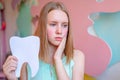 Teen woman pressing her bruised cheek with a painful expression as if she& x27;s having a terrible tooth ache. Holding big Royalty Free Stock Photo